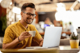 man with laptop and cup of coffee